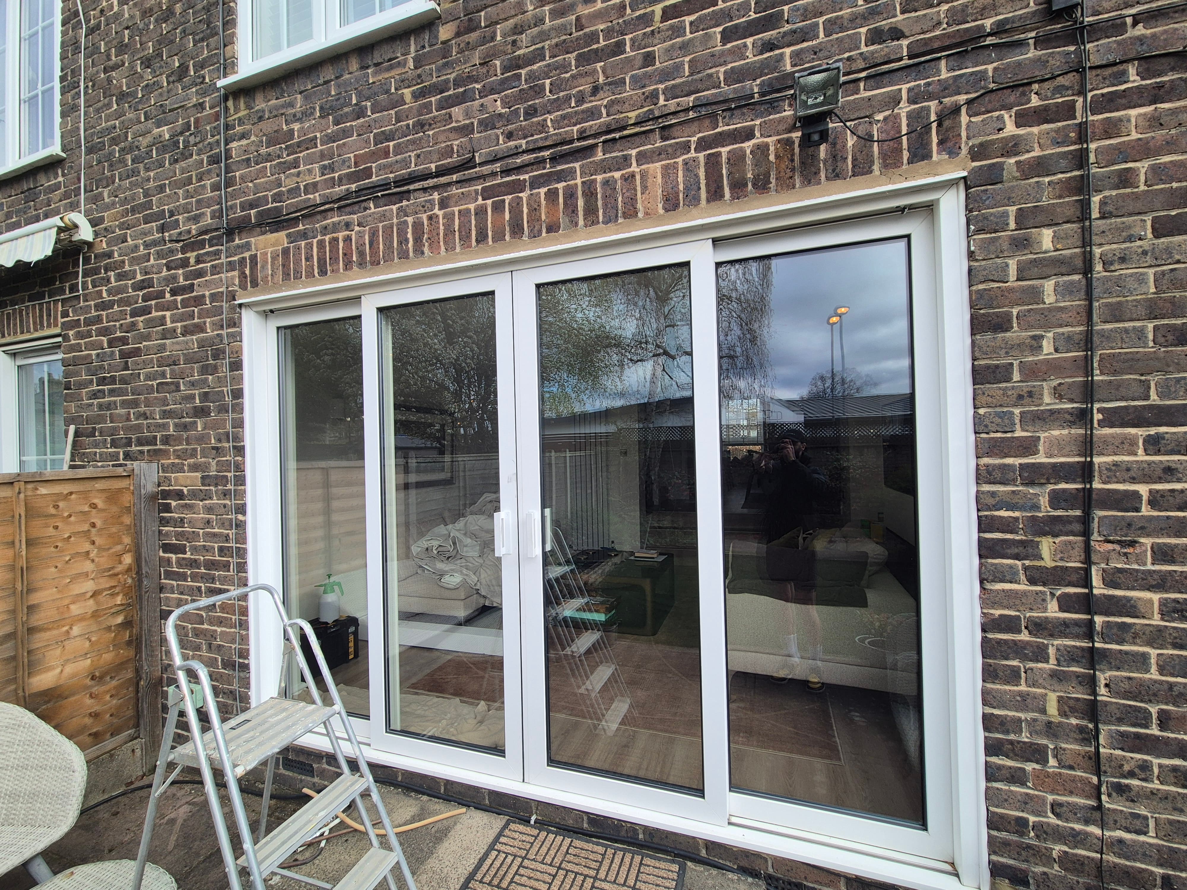 Residential four pane sliding patio doors in Slough before window film installation