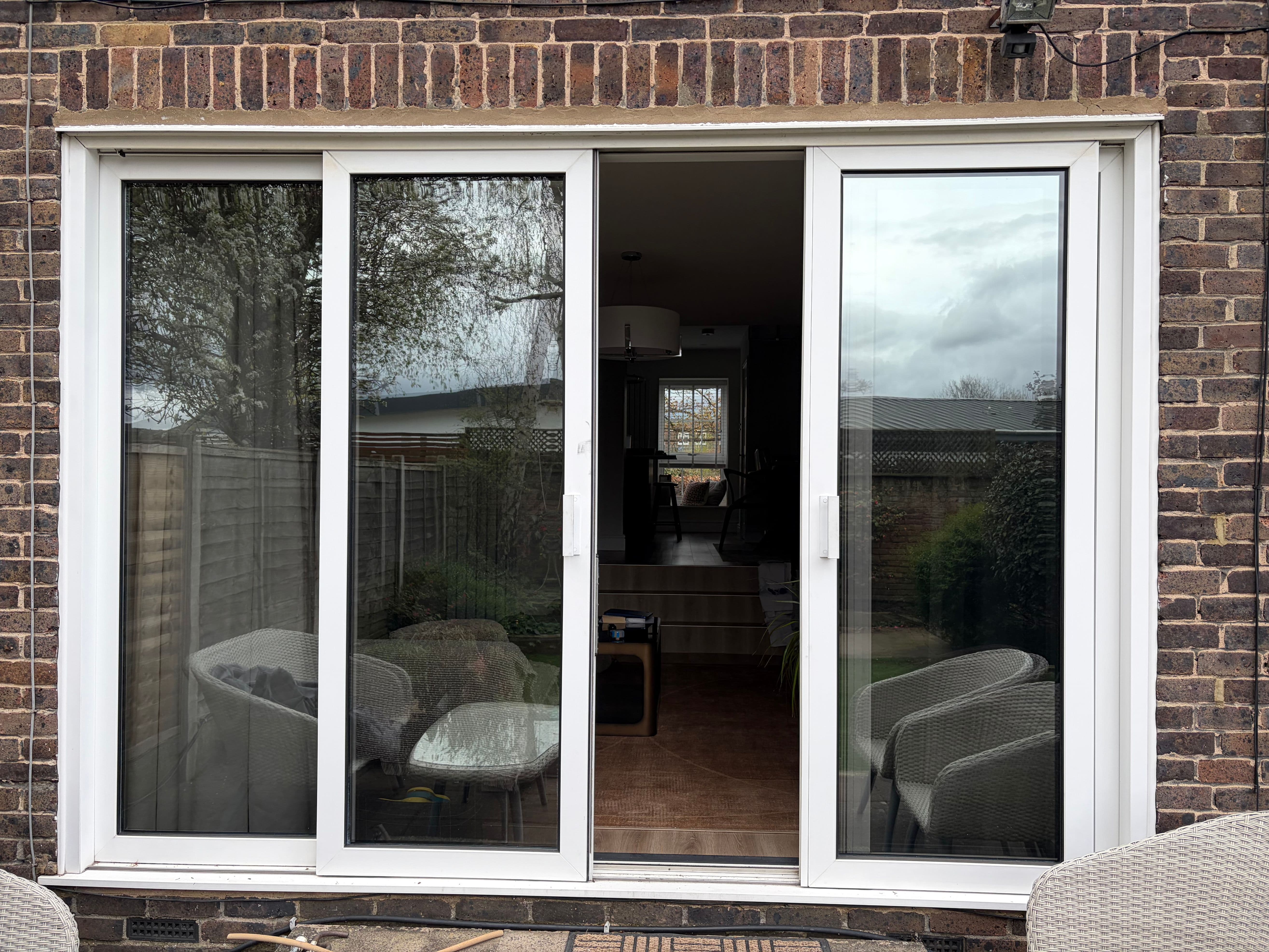 Daytime privacy window film effect on modern sliding doors in a Slough garden